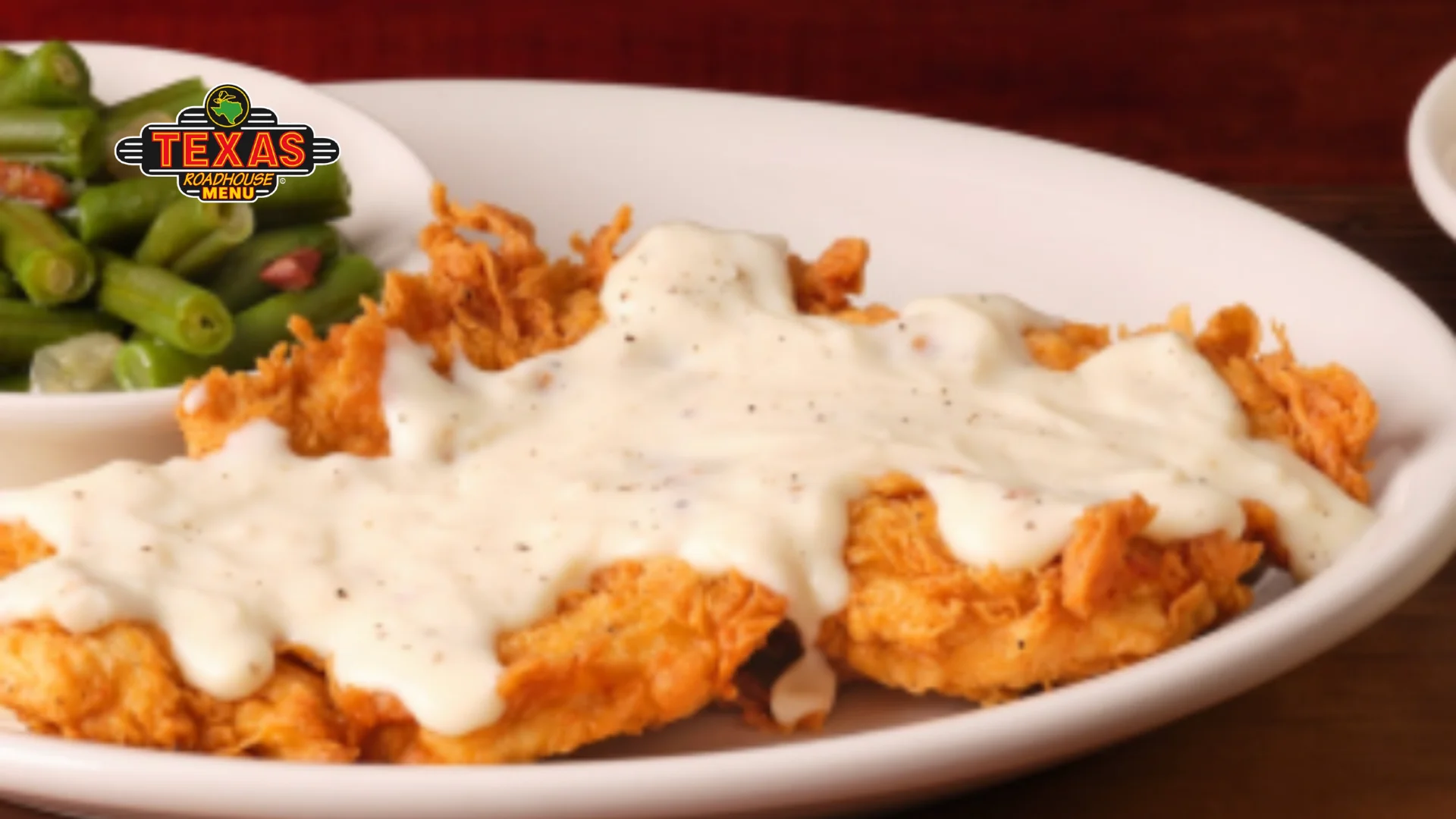 Country Fried Chicken is a plate with extra topping sauces and salad