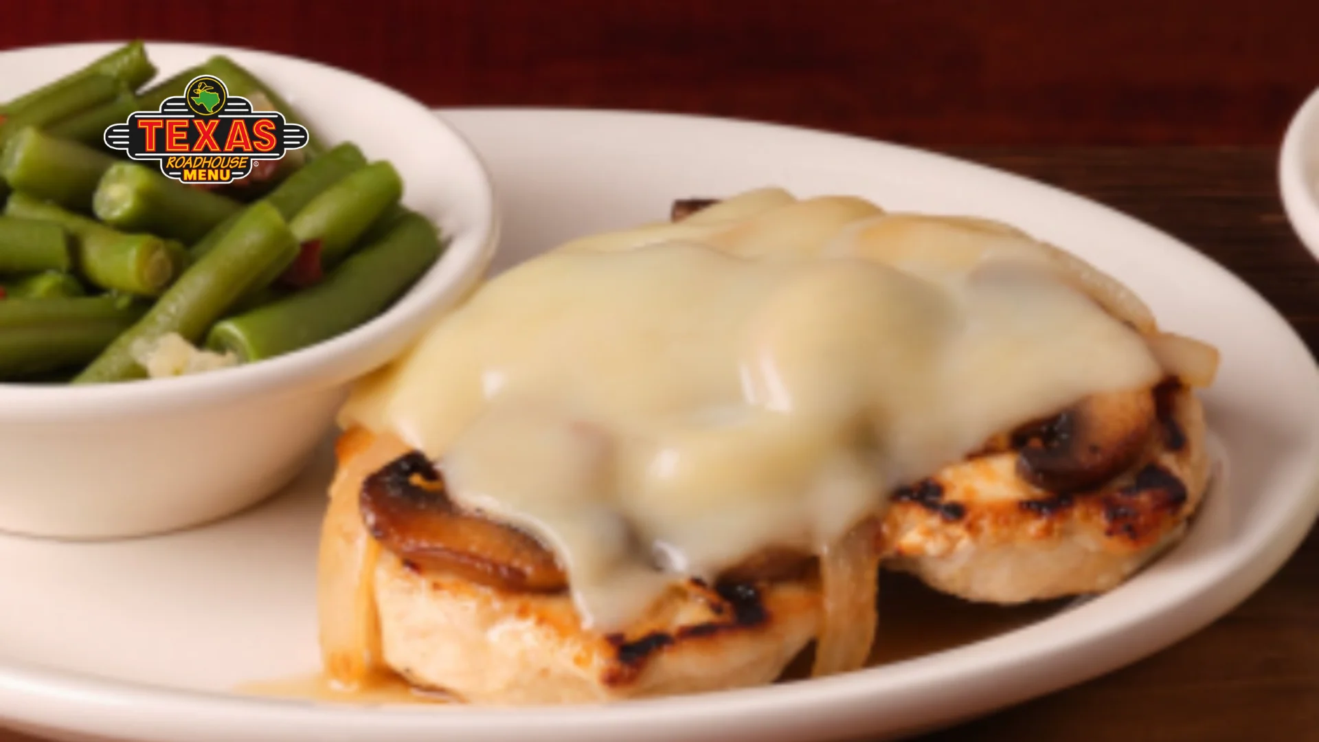 Smothered Chicken topping with cheese and served with salad