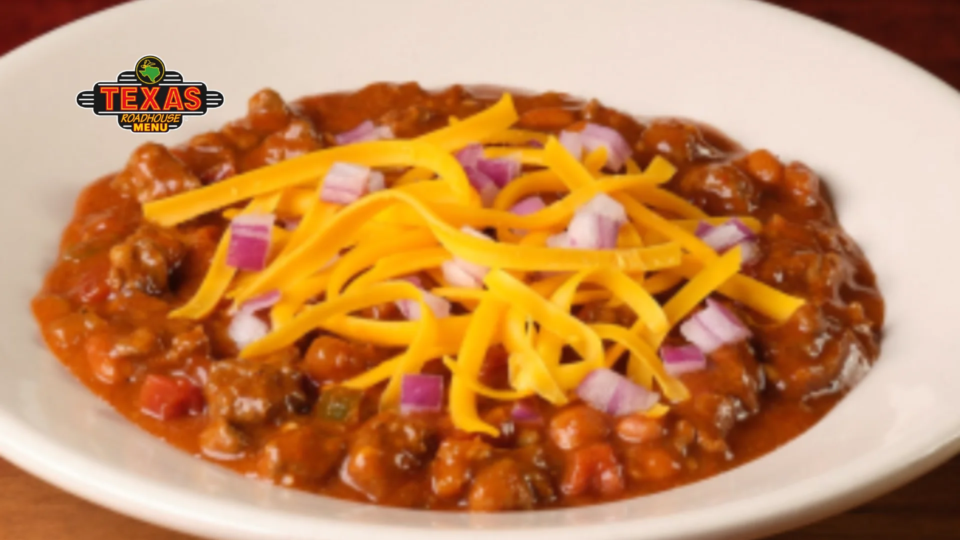 Texas Red Chili served with a plate with cheese and onion